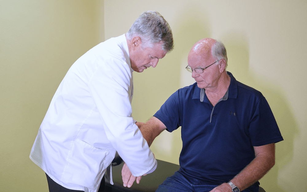 Dr. Timothy Douglass giving the old man arm pain treatment