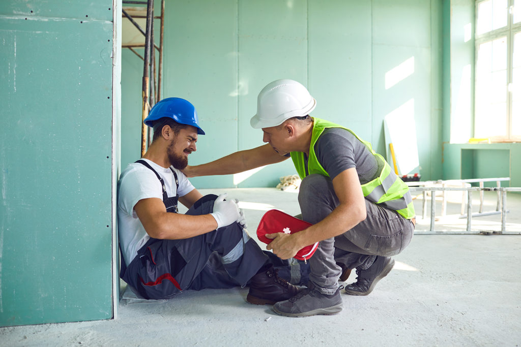 man comforting his co worker who have work injury