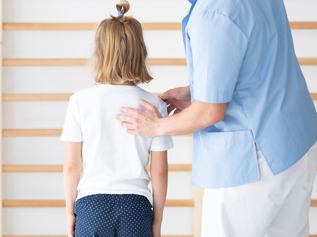 chiropractor checking the girl's back